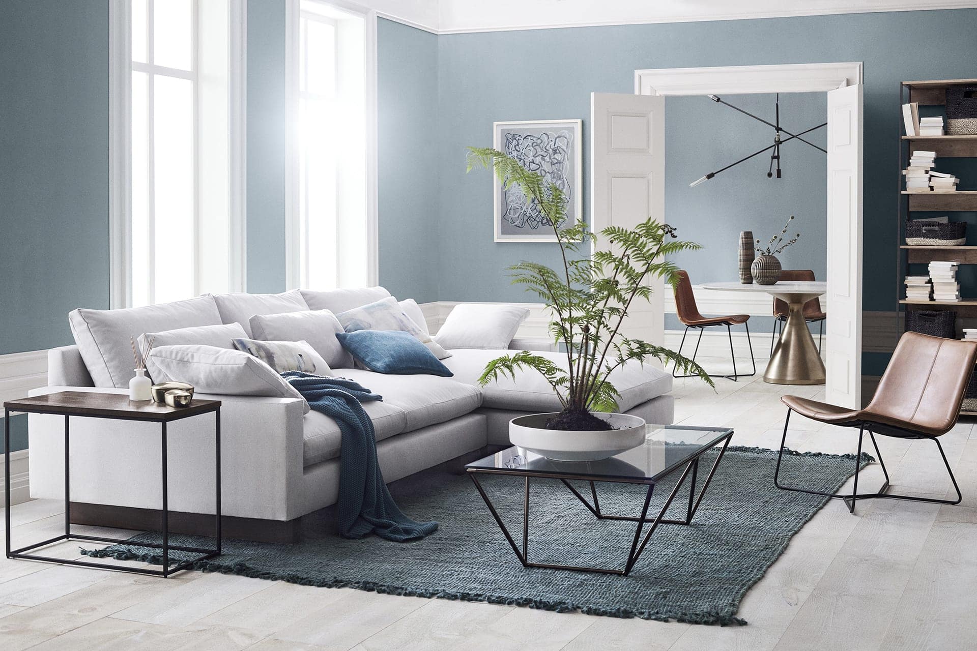 West Elm-Living-room-with-light-blue-walls-and-white-trims